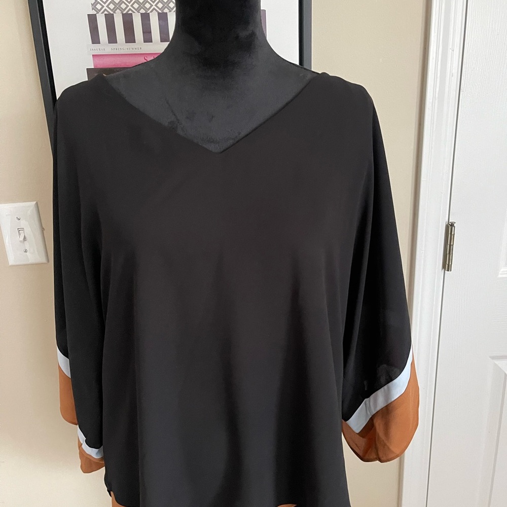 Beautiful White House Black Market dolman sleeve blouse with tan trim